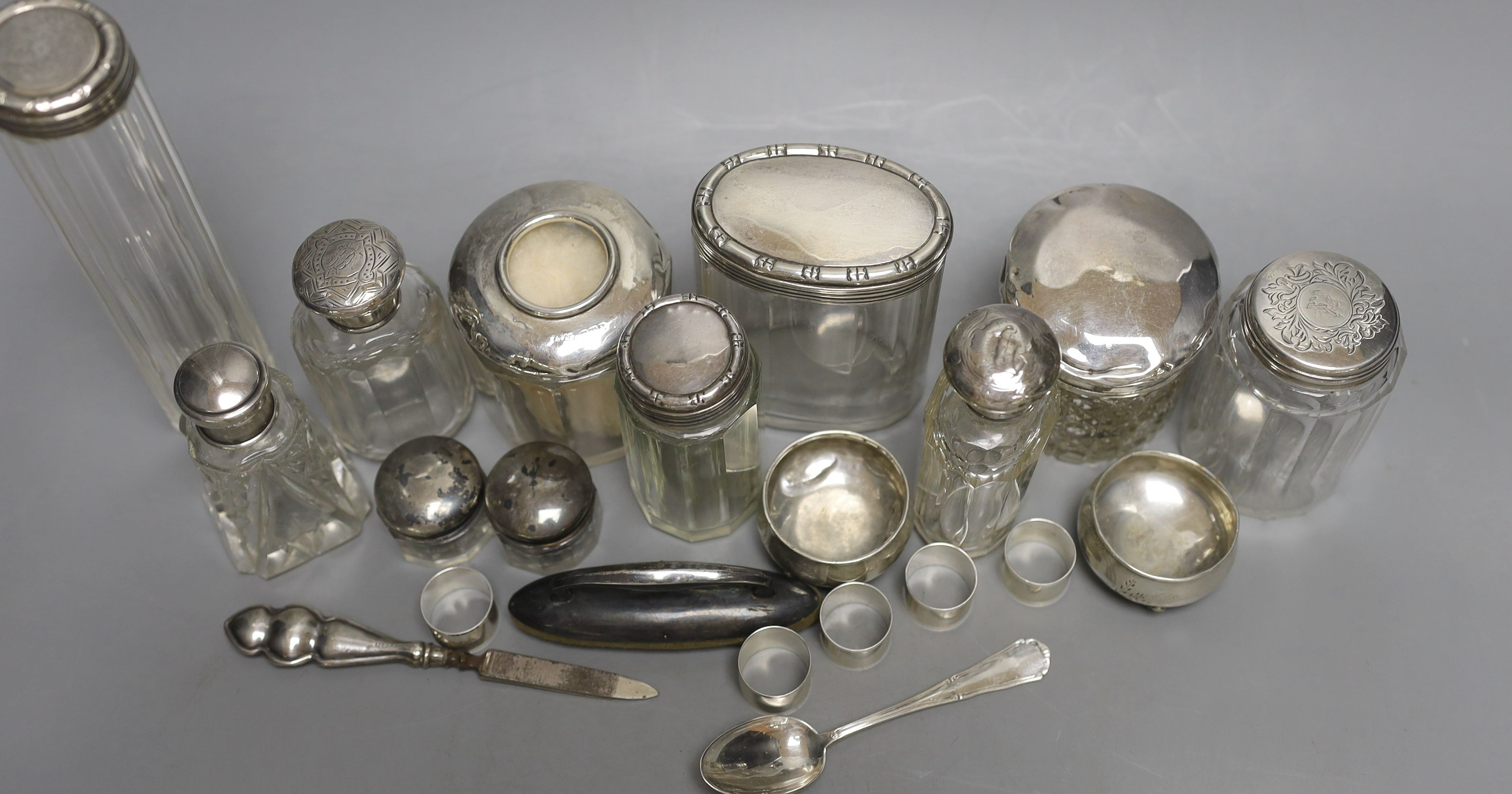 Eleven assorted silver topped glass toilet jars, a pair of 800 salts and eight other items.